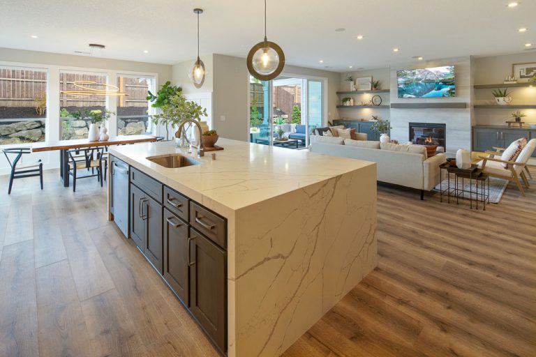 Traditional classic kitchen design with white cabinets, stainless steel appliances, striking granite countertops, and bar-style seating for extended conversations and meals.