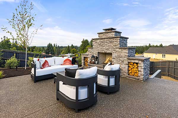 Luxury outdoor living with stacked stone wood fireplace