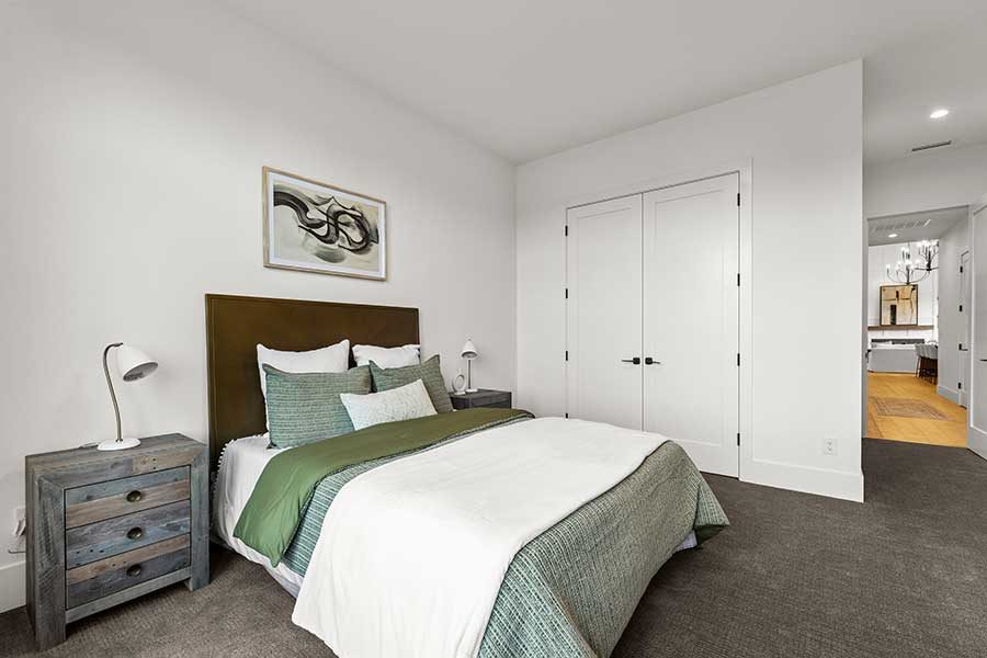 Bedroom and closet of modern custom home by Kingston Homes